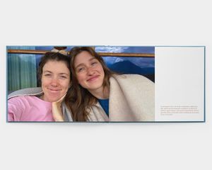 En öppen fotobok med en bild av två leende kvinnor